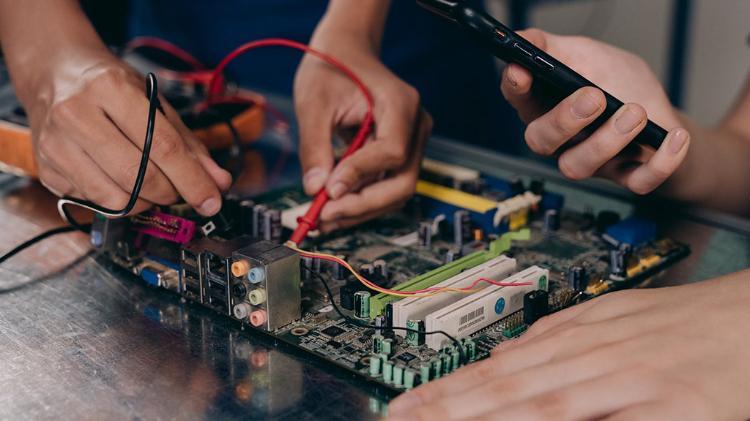 two students creating a electrical board