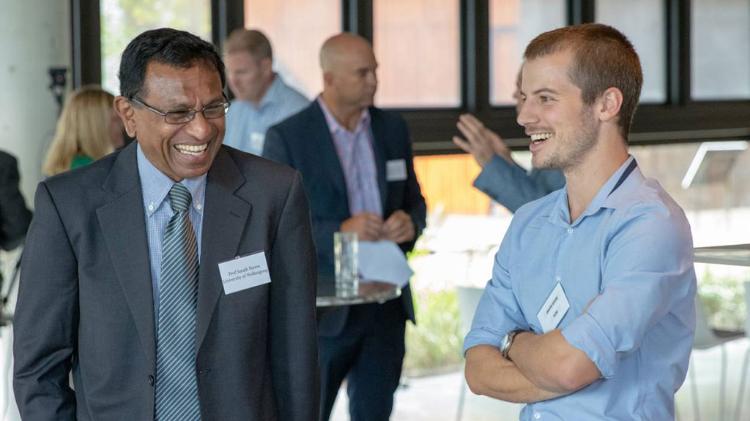2 men laughing at Ecojule event