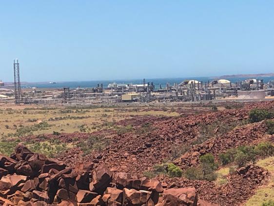 Liquid natural gas plant in vicinity of natural landscape of Murujuga