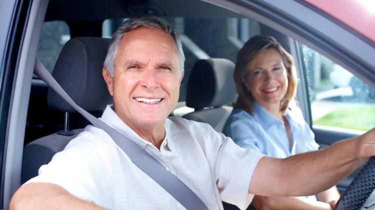 Senior man and woman in car