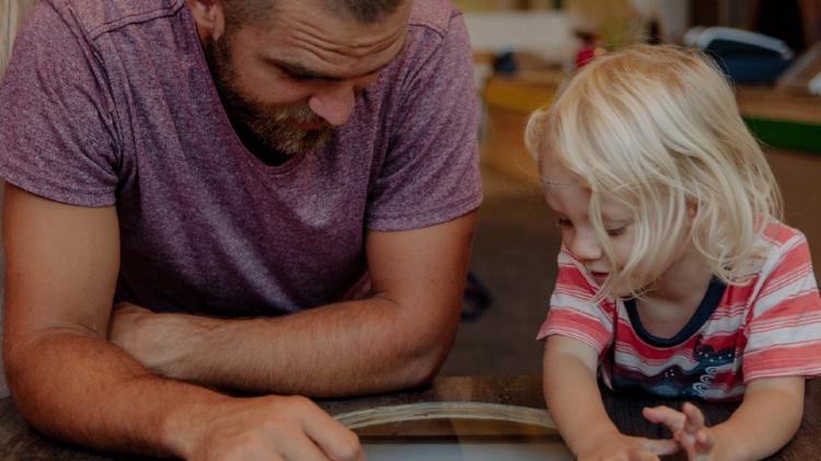 Father and child reading a book