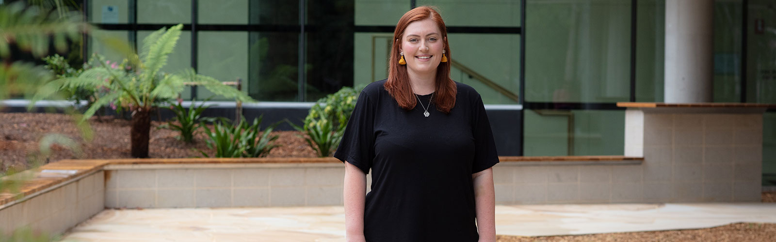 Postgraduate Student, Sarah McInnes standing in the garden of building 29