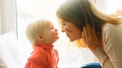 Baby and mother giving butterfly kisses