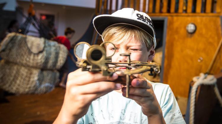 Child playing with compass in Discovery Space