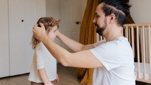 Dad putting a flower crown on daughters head