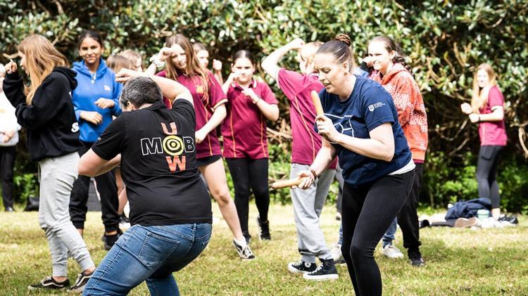 Indigenous and Non-Indigenous people are taking part in a Indigenous Literacy Day dance on campus.