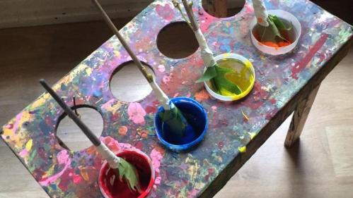 Tubs of paint for kids with paint brushes