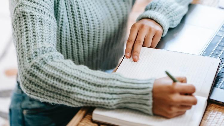 Female student writing in book
