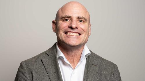 Tony Okely smiling at camera, Staff portrait 2022