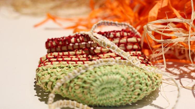 A weave basket. Colours are green, red and cream