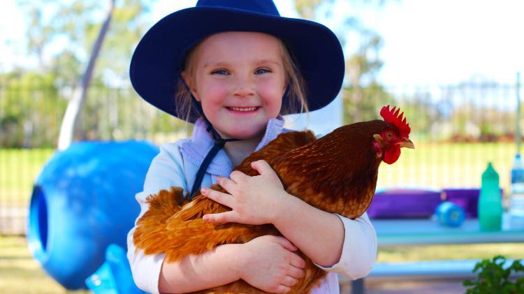 girl holding a chicken