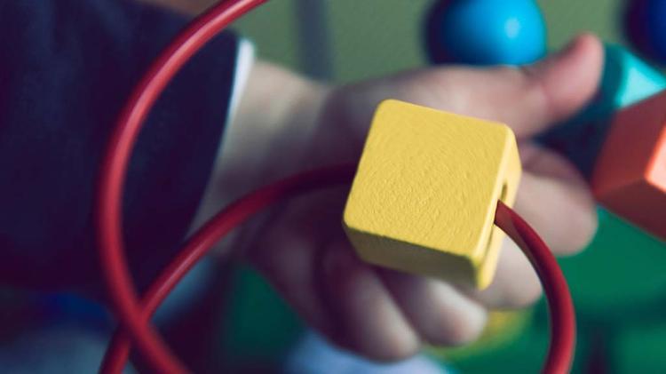 Close up of Childs hands playing with toy