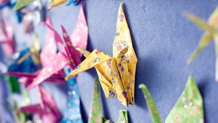 A paper crane on a wall at a primary school