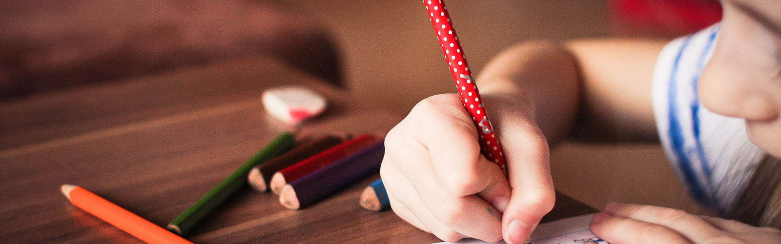 Child drawing at table