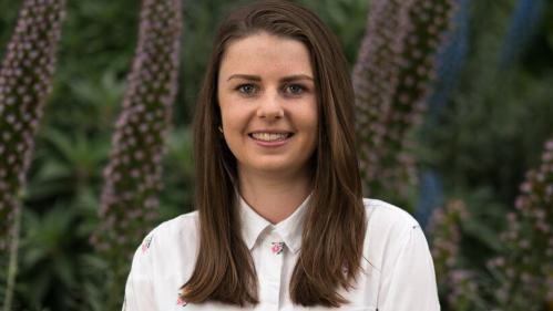 Headshot of Brittany Madeley standing infront of trees