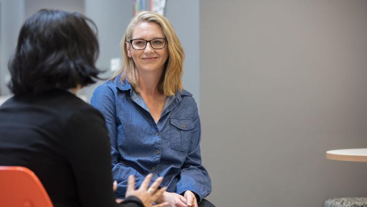 Two women sitting in a consultation type situation