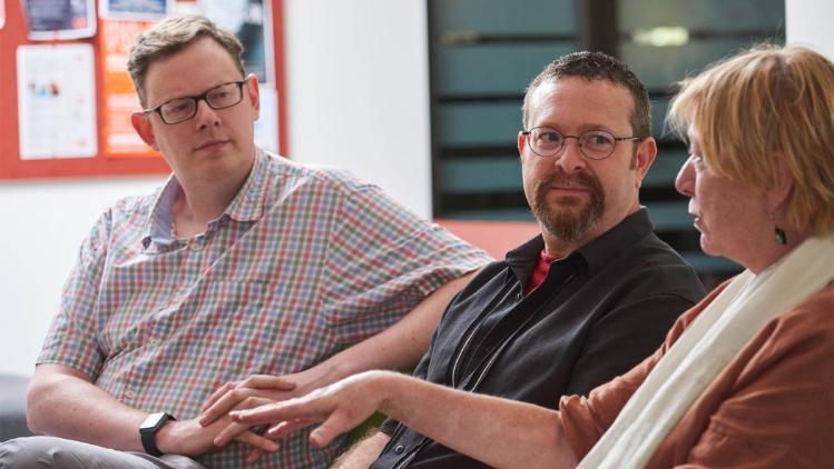 Group of academic staff talking in research hub