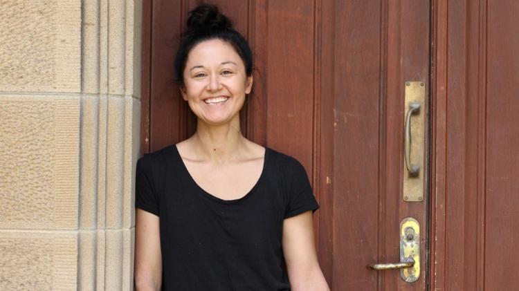 Elena Walsh standing against wall