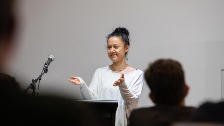 woman speaking at lectern