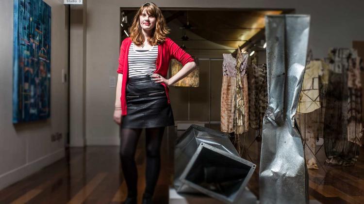 Nicola Dowse standing in studio with artwork