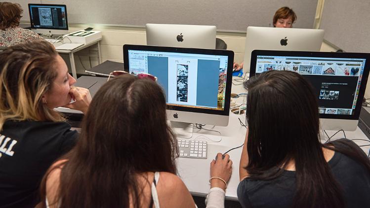 Students edit photos on computer