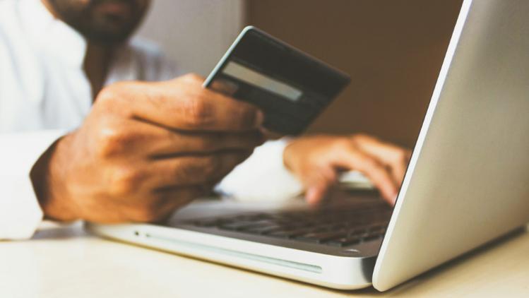 Man on laptop making a purchase
