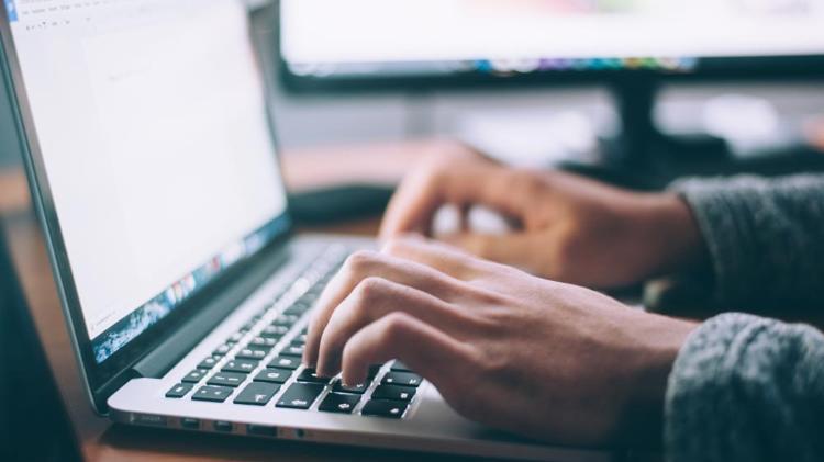 Person typing on keyboard