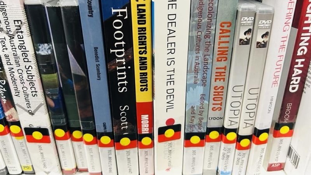 Books stacked on a shelf.