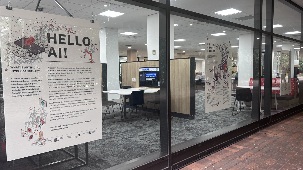 Large posters with AI information displayed on the glass walls of the ������Ƶapp Campus Library