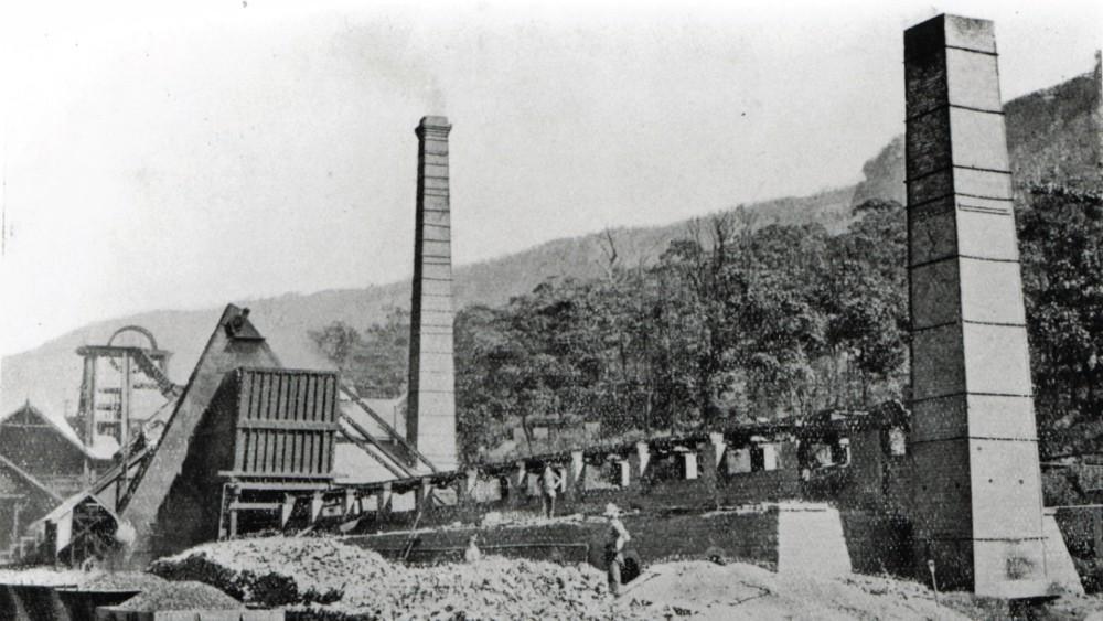Black and white photograph of coke works showing two tall chimneys