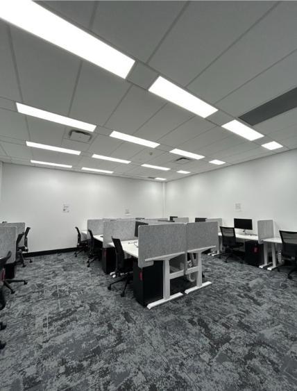 postgraduate room at Wollongong campus Library showing upgraded stand-to-sit desks and BYOD monitors