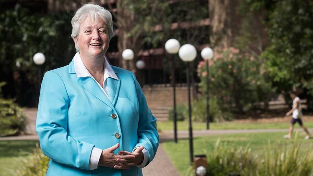 Executive Dean of the Faculty of Science, Medicine and Health, Professor Alison Jones standing in front of the duck pond at Wollongong Campus