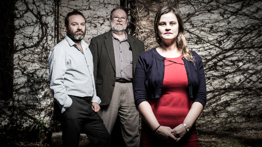 3 academics standing in front of a tree