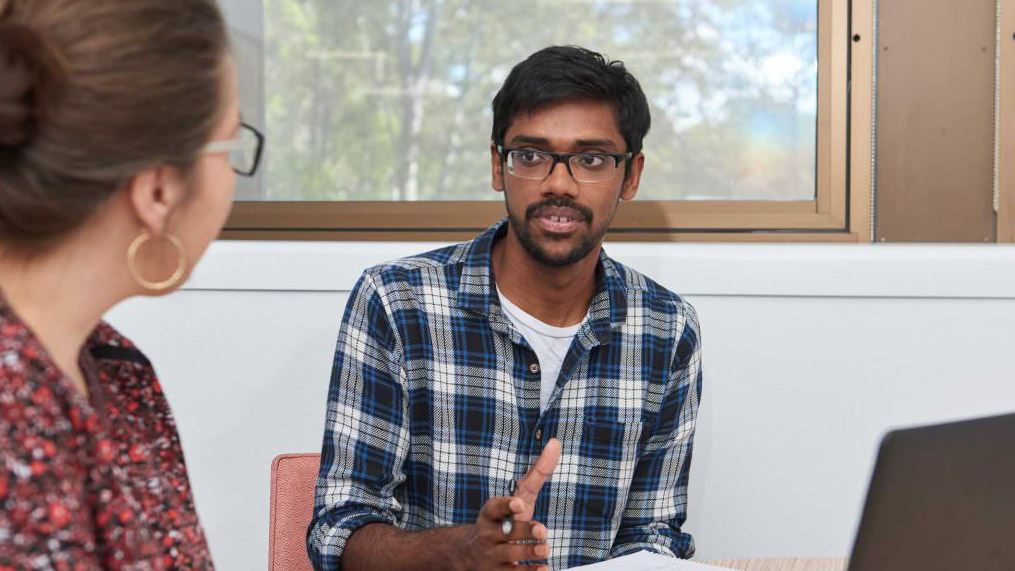 Man asking a question of another person