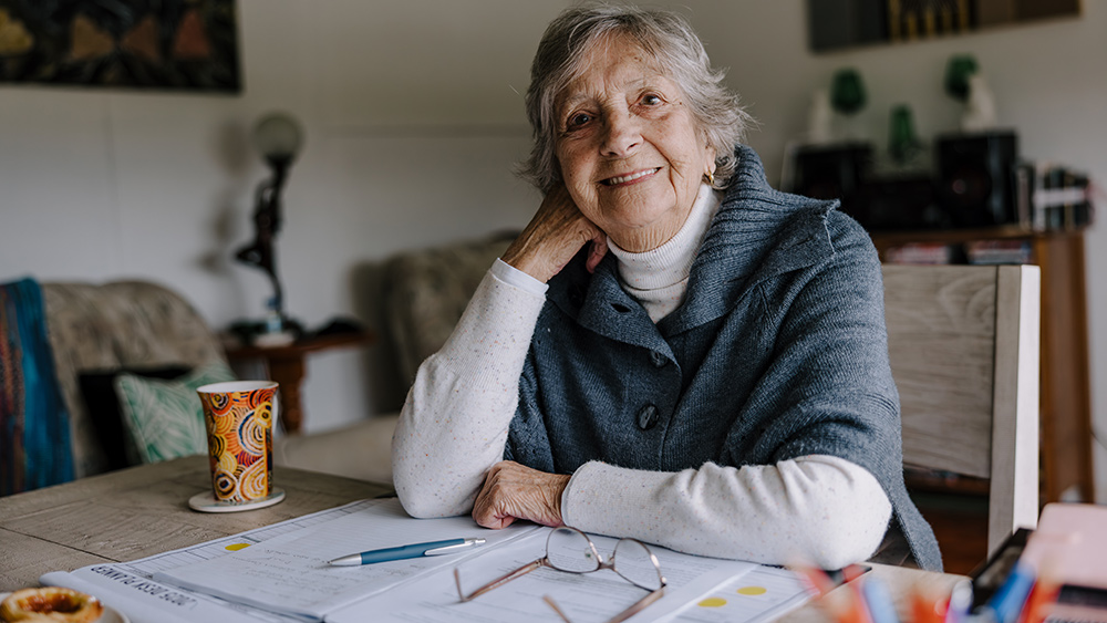Aunty Barb Nicholson seated at her desk at home