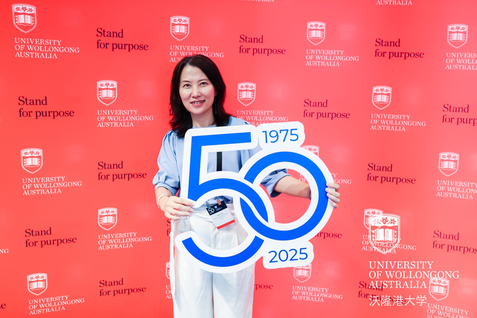 Person holding UOW emoji at Beijing event