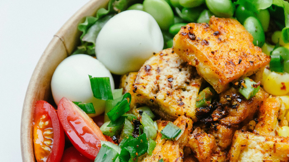 Bowl with tofu, eggs, tomatoes and beans