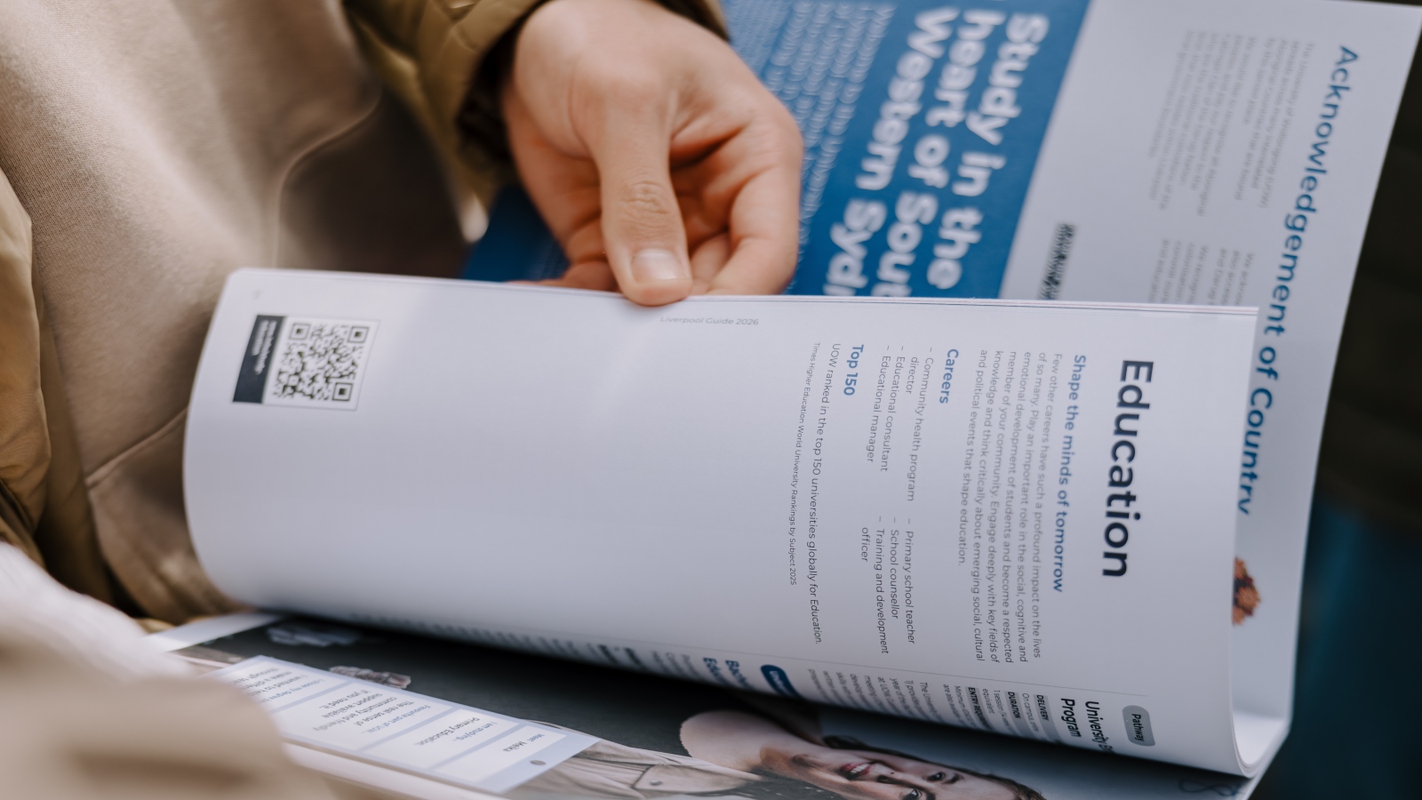 person looking through course guide booklet