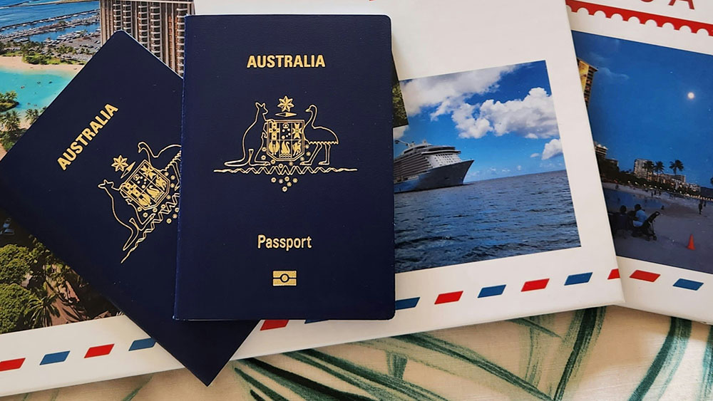 Stock image of Australian passports on a postcard collage background