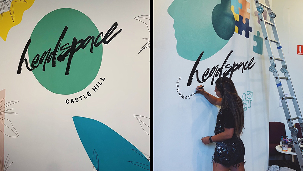 Artist Gillian Dinh paints a green and blue mural backdrop