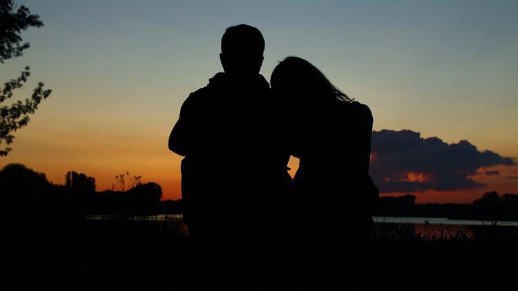 Two students sitting at sunset