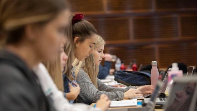 Students in a lecture with laptops