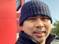Lucky Wuwung smiling at camera, wearing a beanie