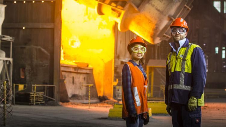 man and woman in industrial steel manufacturing setting