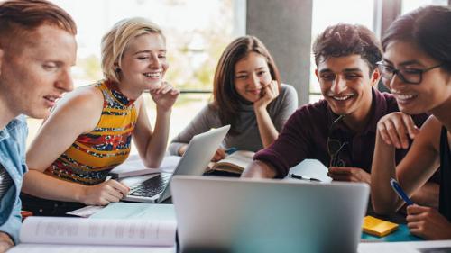 Group works around a laptop