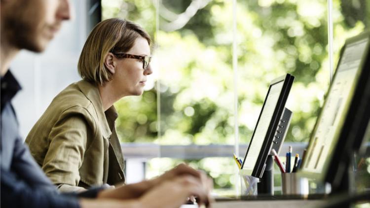 Woman sits at computer