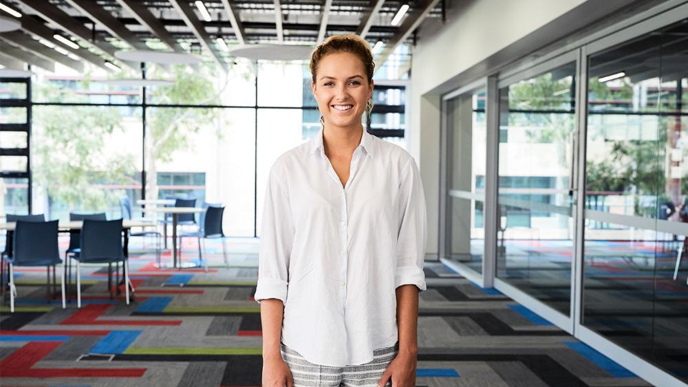 Female student standing in classroom