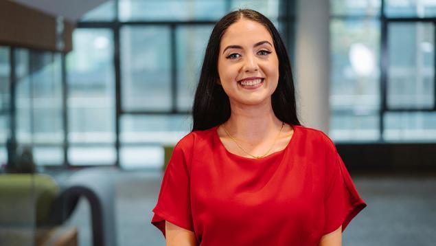 UOW student Anthea stands in a UOW building