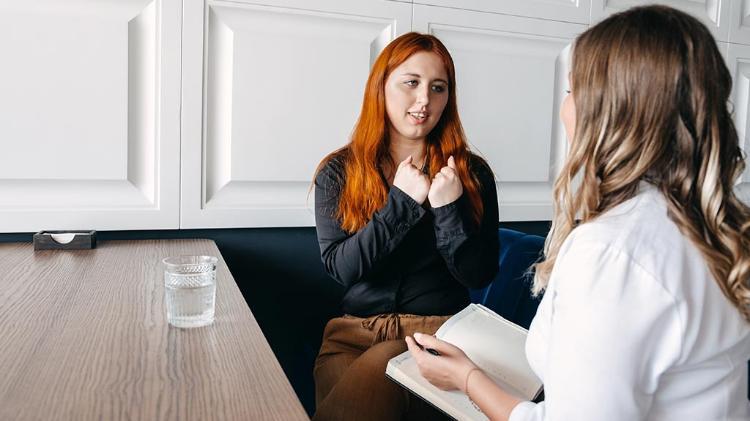 Two people talking to eachother at a table