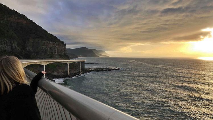 UOW student Madalyn looks out over the Seacliff Bridge.